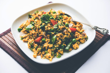 Paneer Bhurji, mildly spiced cottage cheese scramble and served with roti or laccha paratha, selective focus