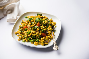 Paneer Bhurji, mildly spiced cottage cheese scramble and served with roti or laccha paratha, selective focus