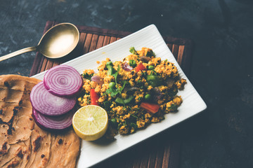 Paneer Bhurji, mildly spiced cottage cheese scramble and served with roti or laccha paratha, selective focus