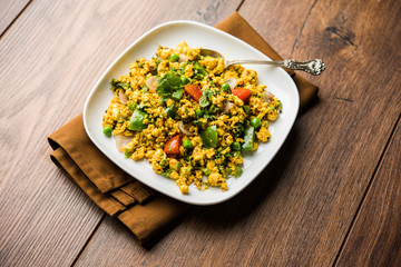 Paneer Bhurji, mildly spiced cottage cheese scramble and served with roti or laccha paratha, selective focus