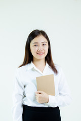 Portrait of a pretty young Asian student in formal white shirt holding a note book on hand on white background.