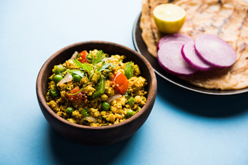 Paneer Bhurji, mildly spiced cottage cheese scramble and served with roti or laccha paratha, selective focus