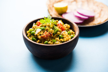 Paneer Bhurji, mildly spiced cottage cheese scramble and served with roti or laccha paratha, selective focus