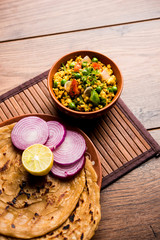 Obraz na płótnie Canvas Paneer Bhurji, mildly spiced cottage cheese scramble and served with roti or laccha paratha, selective focus