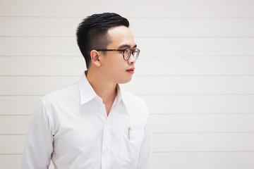 Portrait of Asian handsome business man in the white shirt close up.  Processed in vintage color tone.