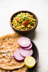Paneer Bhurji, mildly spiced cottage cheese scramble and served with roti or laccha paratha, selective focus