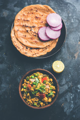 Paneer Bhurji, mildly spiced cottage cheese scramble and served with roti or laccha paratha, selective focus