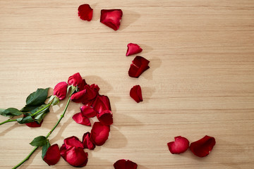 Red Roses on rustic wooden brown background