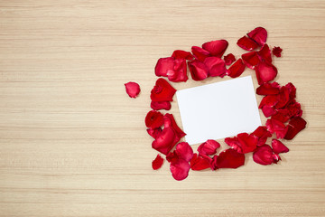 red roses petals and white blank paper