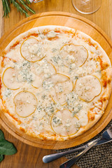 Top view of Italian pizza with blue cheese and pear