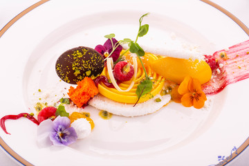 Coconut meringue and sorbet from mango with flowers