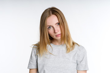 Portrait of a sad woman on a light background.