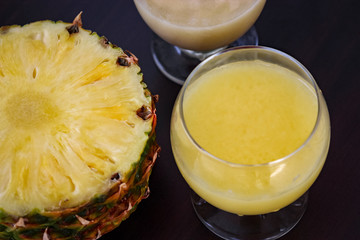 Pineapple smoothie. Healthy food. Fresh juicy breakfast concept. Dark wooden background.