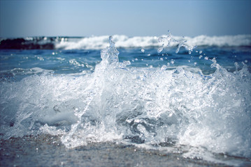 A small wave going ashore with foam