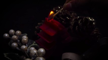 Person Lighting A Christmas Tree Candle
