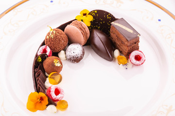 Truffles, cakes and chocolates with fruit jelly and fresh berries