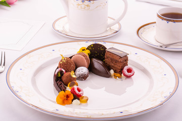 Giving of chocolate desserts with a cup of black tea