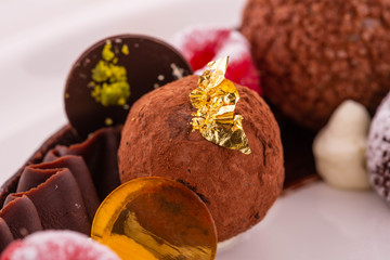 Handmade chocolate truffle with fruit jelly and chocolate shaving