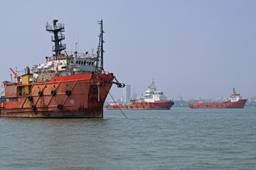 Fototapeta premium Commercial shipping at anchor in the Arabian Sea off the coast of Mumbai which is the busiest port in South Asia