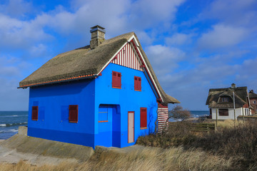 Fototapeta na wymiar Beautiful blue beach house, by the Baltic Sea in Heiligenhafen.