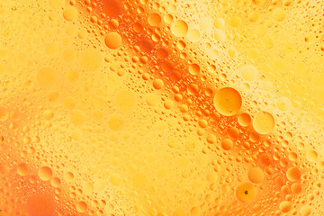 water drops on glass with orange background, close-up 
