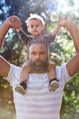 dad gives son piggy back ride