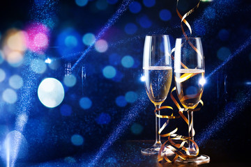 two glasses of champagne in the spotlight - new year celebration