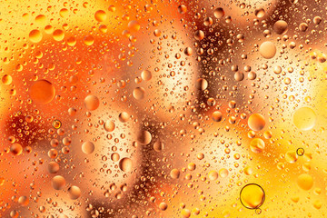 water drops on glass with purple and pink background, close-up 