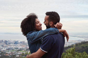 couple smiling at each other while hugging