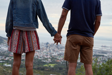 anonymous  african couple holding hands on a peak