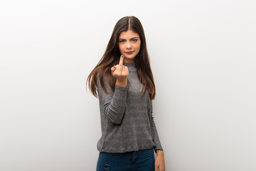 Teenager girl on isolated white backgorund making horn gesture