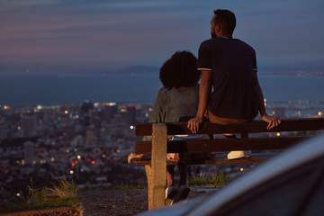 Couple enjoying the city lights at twilight