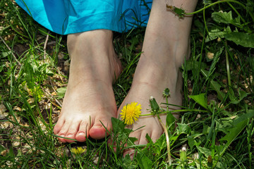 Women's natural feet with unpainted nails on the toes close-up.