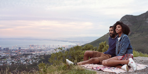 Couple on romantic date outdoors looking out on viewpoint