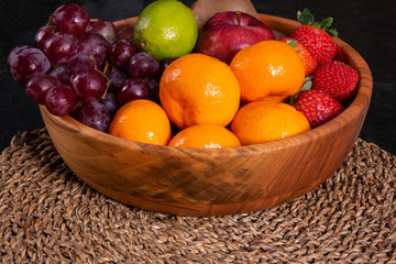 Healthy food: mix from fruits in bowl, old marble background, selective focus