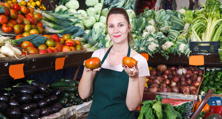 seller woman who is holding tomato
