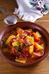 Goulash soup bograch in a bowl. Hungarian dish. Stew, made with beef, bacon, sausages, potatoes and carrots