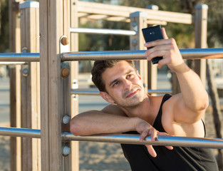 Fototapeta na wymiar Male athlete taking selfie on beach