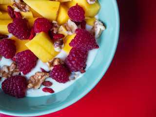 Delicious fruit bowl with red background