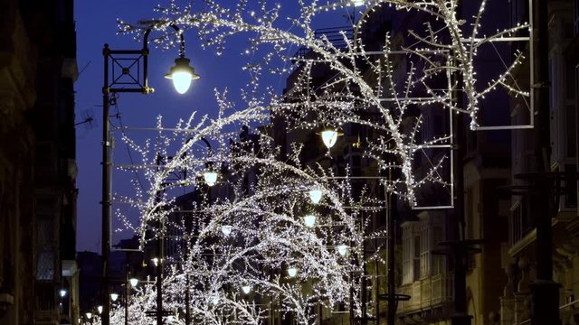 The city is decorated for Christmas with lights, ornaments and street decorations. 4K