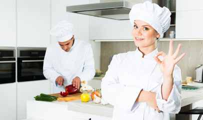 Portrait of the woman proffesional who is posing in the kitchen