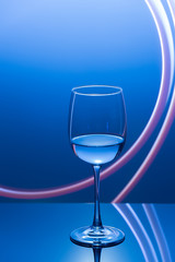 Drink at bar in a night time, wine glass with white wine and freeze light on a background. New year party drink.