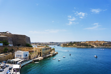 Fototapeta na wymiar VALLETTA, MALTA - June 28, 2017: Typical Seaside port in Valletta in Malta