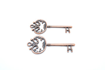 Vintage copper keys on white background close up