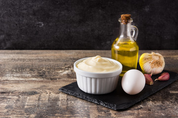 Aioli sauce and ingredients on wooden table. Copyspace

