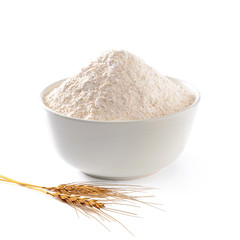 Whole flour in bowl with wheat ears isolated on white background