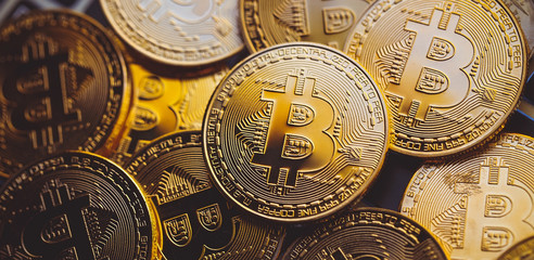 Bitcoin coins on laptop keyboard. Cryptocurrency.