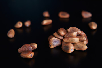 pine nuts on a black background