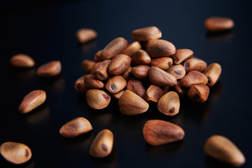 pine nuts on a black background