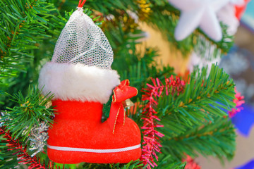 Christmas decoration in the form of a red boot on branches Christmas tree